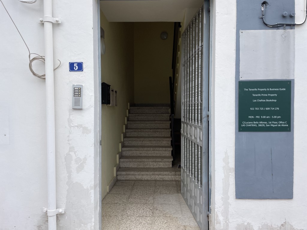 Shows the entrance to the bookshop and stairwell